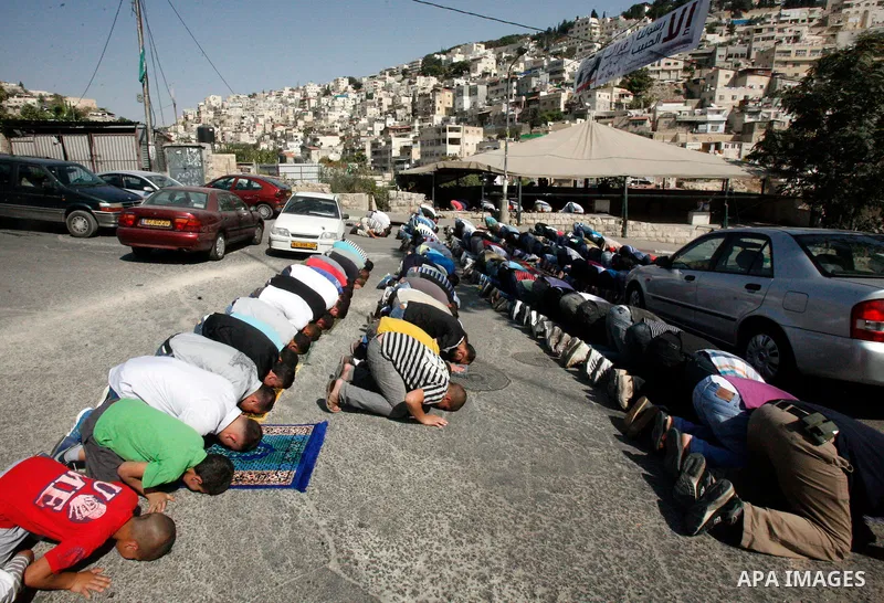 Palestinian Muslim worshippers attend Friday prayers outside a protest tent against the continuing 'Judaization of Jerusalem' by Jewish settlers, in the mostly Arab neighbourhood of Silwan in east Jerusalem on Oct. 19, 2...