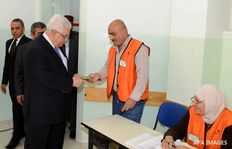 Palestinian President Mahmoud Abbas casts his vote for municipal elections at a polling station in Al-Bireh, next to the West Bank city of Ramallah, October 20, 2012. Photo by Thaer Ganaim
