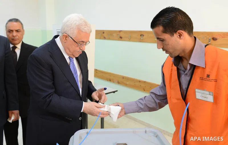 Palestinian President Mahmoud Abbas casts his vote for municipal elections at a polling station in Al-Bireh, next to the West Bank city of Ramallah, October 20, 2012. Photo by Thaer Ganaim