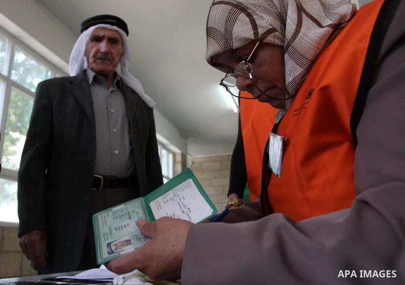 A Palestinian man casts his vote for the municipal elections at a polling station in Al-Bireh, a town adjacent to the West Bank city of Ramallah, on October 20, 2012. Palestinians in the West Bank voted in local election...