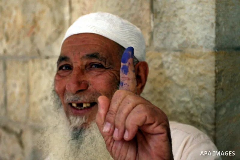 A Palestinian man casts his vote for the municipal elections at a polling station in Al-Bireh, a town adjacent to the West Bank city of Ramallah, on October 20, 2012. Palestinians in the West Bank voted in local election...