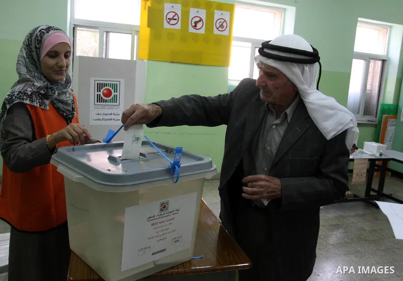 A Palestinian man casts his vote for the municipal elections at a polling station in Al-Bireh, a town adjacent to the West Bank city of Ramallah, on October 20, 2012. Palestinians in the West Bank voted in local election...
