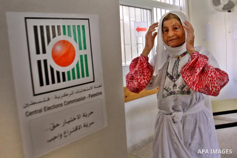 A Palestinian woman casts his vote for the municipal elections at a polling station in the West Bank village of of Deir al-Ghusun north of Tulkarm, on October 20, 2012. Palestinians in the West Bank voted in local electi...