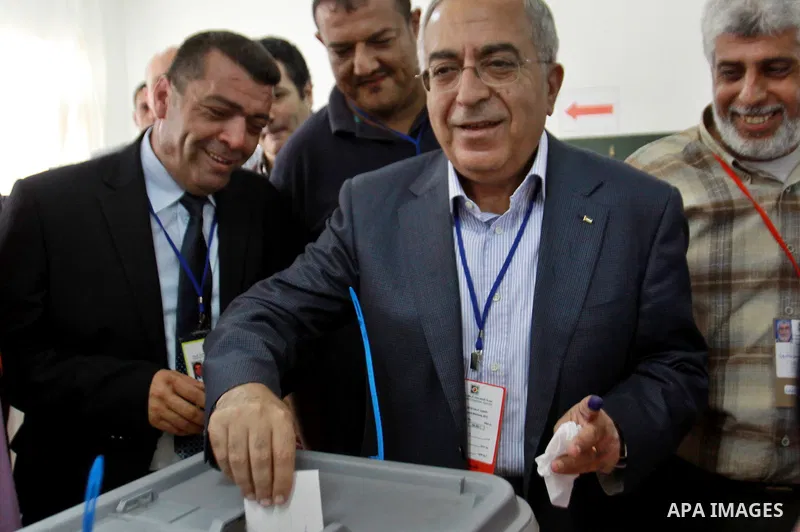 Palestinian Prime Minister Salam Fayyad casts his vote for the municipal elections at a polling station in the West Bank village of of Deir al-Ghusun north of Tulkarm, on October 20, 2012. Palestinians in the West Bank v...
