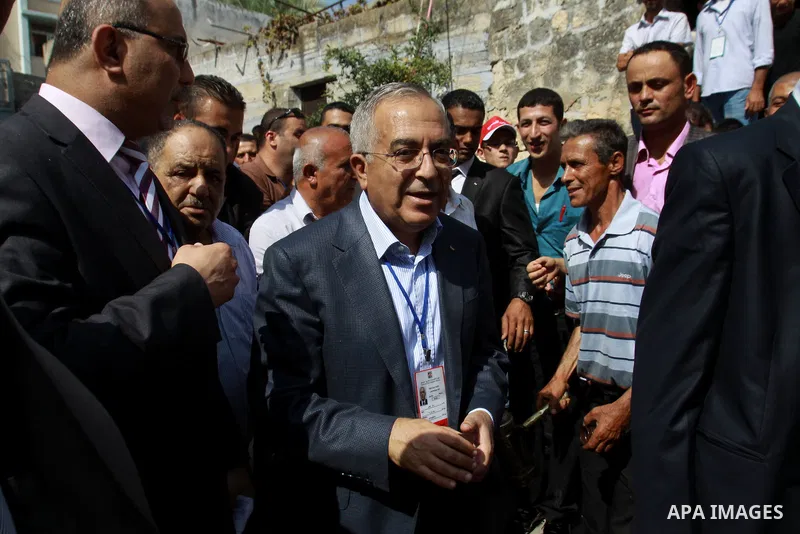 Palestinian Prime Minister Salam Fayyad casts his vote for the municipal elections at a polling station in the West Bank village of of Deir al-Ghusun north of Tulkarm, on October 20, 2012. Palestinians in the West Bank v...