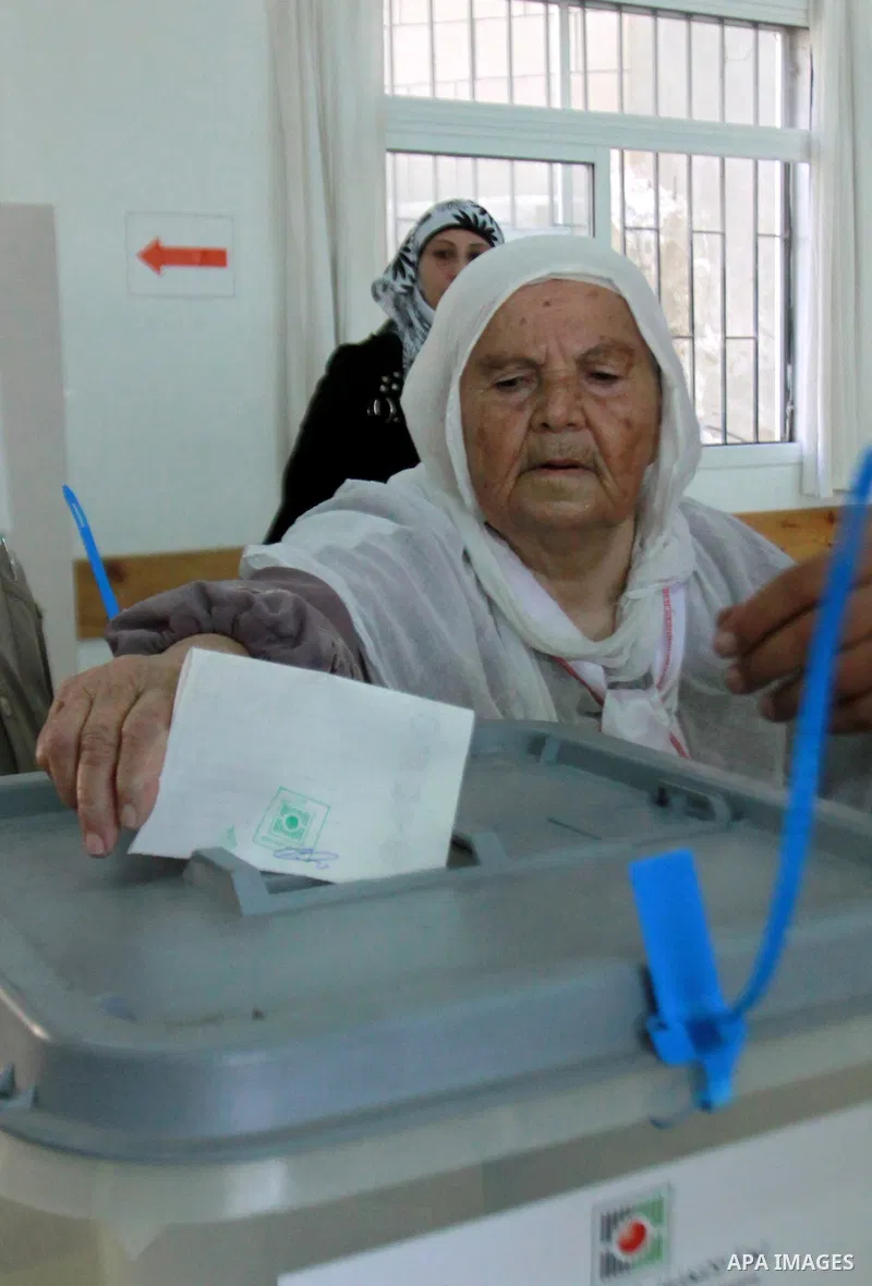 A Palestinian woman casts his vote for the municipal elections at a polling station in the West Bank village of of Deir al-Ghusun north of Tulkarm, on October 20, 2012. Palestinians in the West Bank voted in local electi...