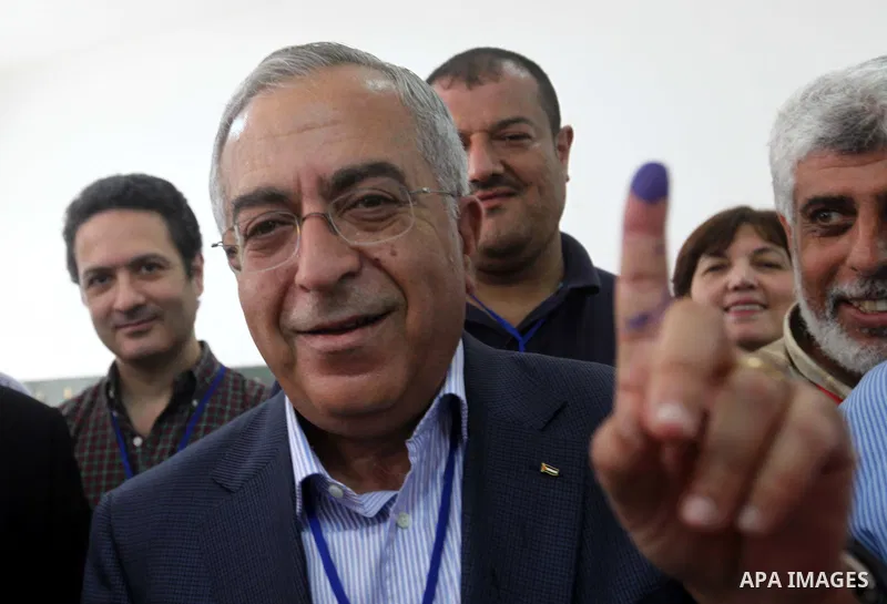 Palestinian Prime Minister Salam Fayyad casts his vote for the municipal elections at a polling station in the West Bank village of of Deir al-Ghusun north of Tulkarm, on October 20, 2012. Palestinians in the West Bank v...