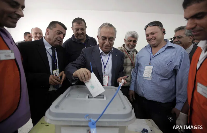 Palestinian Prime Minister Salam Fayyad casts his vote for the municipal elections at a polling station in the West Bank village of of Deir al-Ghusun north of Tulkarm, on October 20, 2012. Palestinians in the West Bank v...
