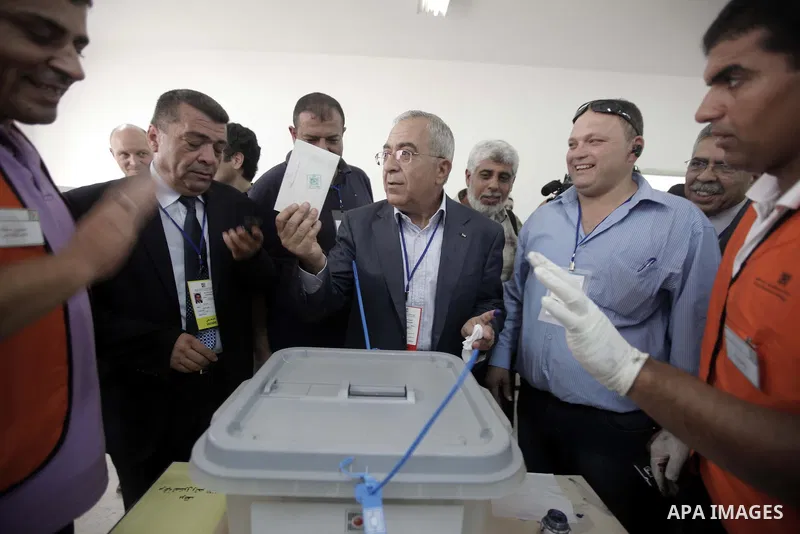 Palestinian Prime Minister Salam Fayyad casts his vote for the municipal elections at a polling station in the West Bank village of of Deir al-Ghusun north of Tulkarm, on October 20, 2012. Palestinians in the West Bank v...