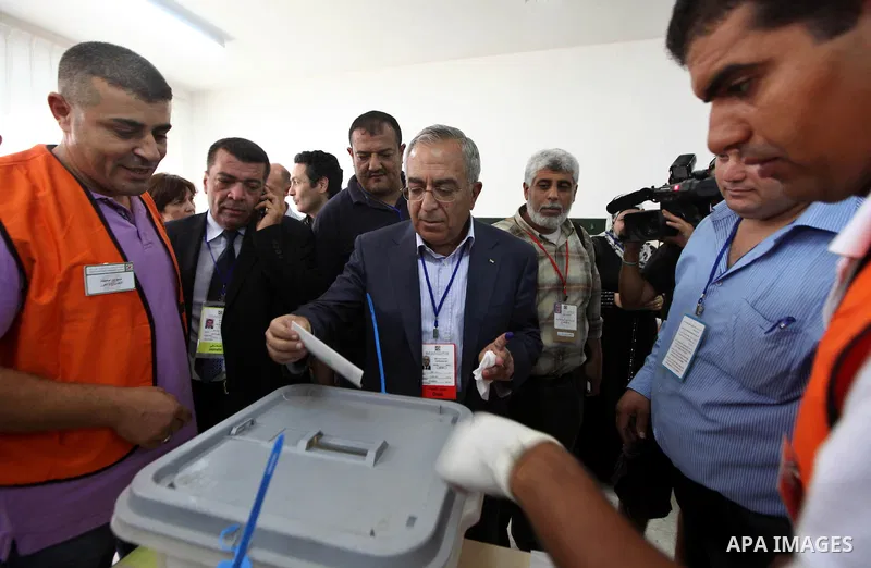 Palestinian Prime Minister Salam Fayyad casts his vote for the municipal elections at a polling station in the West Bank village of of Deir al-Ghusun north of Tulkarm, on October 20, 2012. Palestinians in the West Bank v...