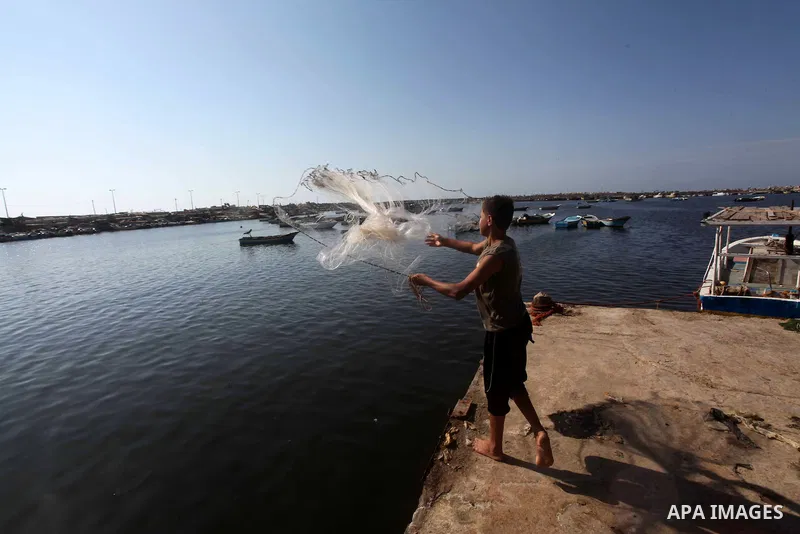 Palestinian fishermen prepare their nets in Gaza City's harbour on October 20, 2012. Israeli soldiers commandeered a vessel carrying pro-Palestinian activists destined for Gaza on Saturday, cutting off communications and...