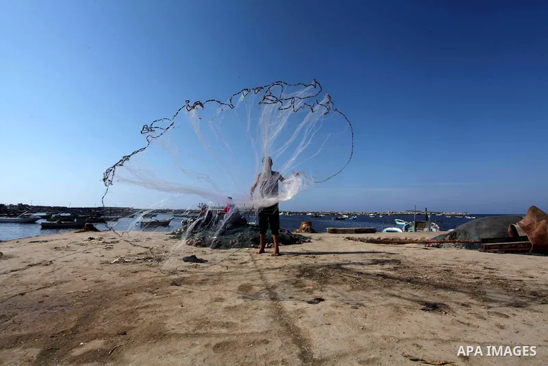 Palestinian fishermen prepare their nets in Gaza City's harbour on October 20, 2012. Israeli soldiers commandeered a vessel carrying pro-Palestinian activists destined for Gaza on Saturday, cutting off communications and...
