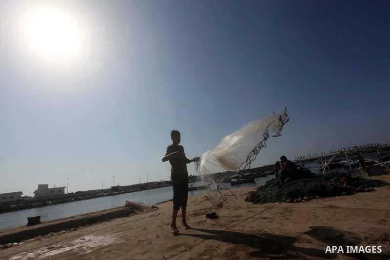 Palestinian fishermen prepare their nets in Gaza City's harbour on October 20, 2012. Israeli soldiers commandeered a vessel carrying pro-Palestinian activists destined for Gaza on Saturday, cutting off communications and...