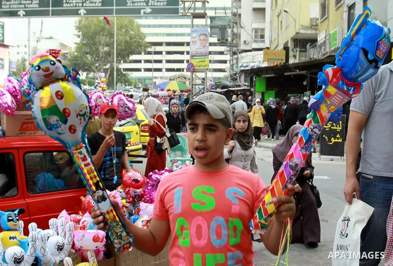 A Palestinian vendor sells ballons in preparing to the celebration of Eid al-Adha festival at a market in the West Bank city of Nablus, oct. 21, 2012. Muslims around the world prepare to celebrate Eid Al-Adha, which acco...