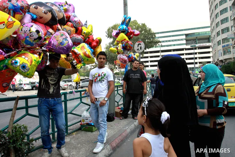 A Palestinian vendor sells ballons in preparing to the celebration of Eid al-Adha festival at a market in the West Bank city of Nablus, oct. 21, 2012. Muslims around the world prepare to celebrate Eid Al-Adha, which acco...