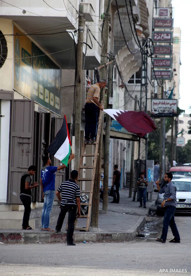 The Qatari and Palestinian (red,black,white, green) flags are attached to lamp posts along a main street in Gaza City on October 21, 2012, the day before the Emir of Qatar's official visit to the strip. Emir of Qatar Ham...