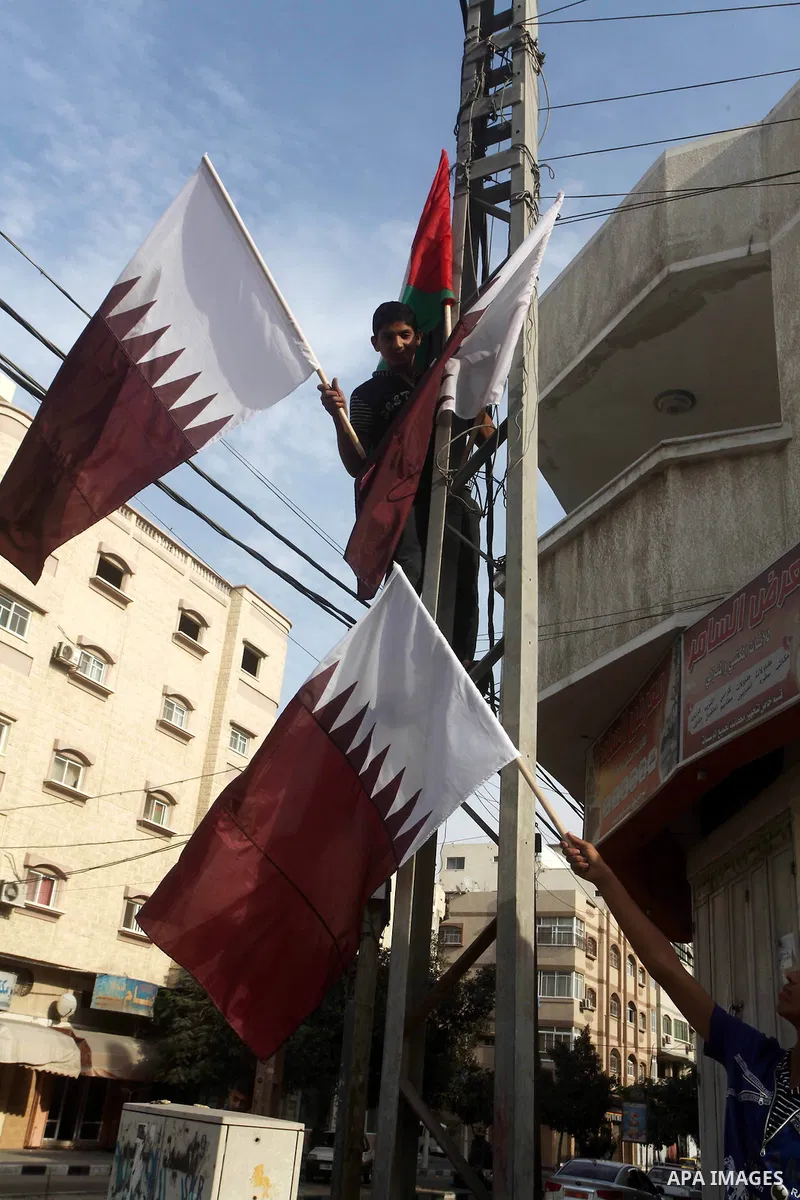 The Qatari and Palestinian (red,black,white, green) flags are attached to lamp posts along a main street in Gaza City on October 21, 2012, the day before the Emir of Qatar's official visit to the strip. Emir of Qatar Ham...