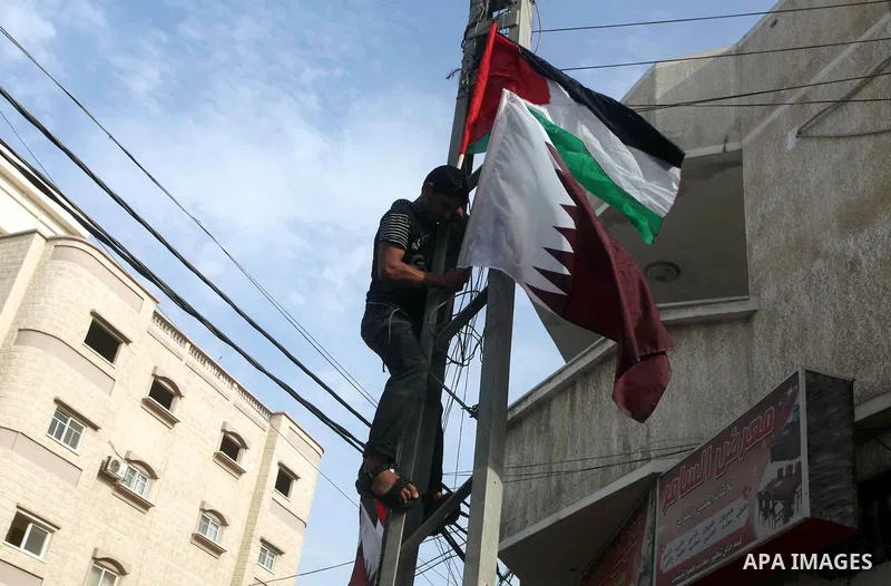 The Qatari and Palestinian (red,black,white, green) flags are attached to lamp posts along a main street in Gaza City on October 21, 2012, the day before the Emir of Qatar's official visit to the strip. Emir of Qatar Ham...