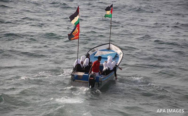 Palestinian girls ride on the deck of a boat off the coast of Gaza city during a school trip on October 21, 2012. Gaza beach is the only outlet for the Palestinians after tightening the Israeli blockade on the Gaza Strip...
