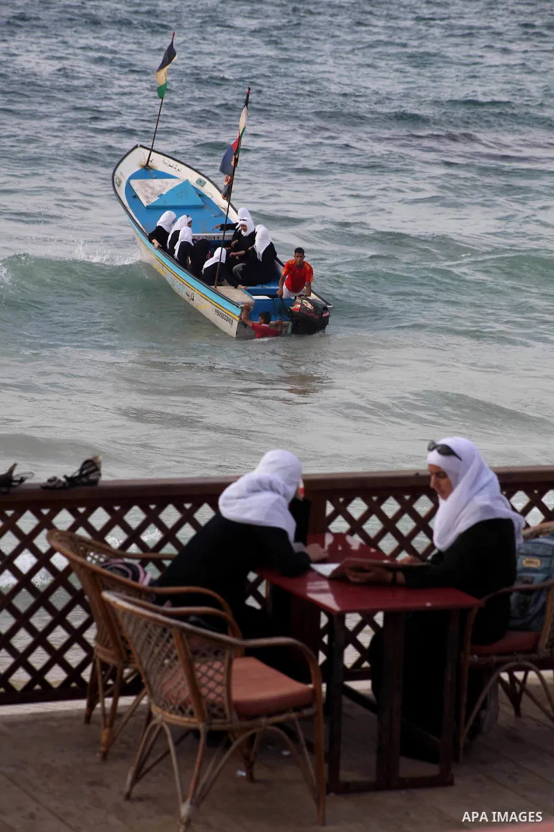 Palestinian girls ride on the deck of a boat off the coast of Gaza city during a school trip on October 21, 2012. Gaza beach is the only outlet for the Palestinians after tightening the Israeli blockade on the Gaza Strip...