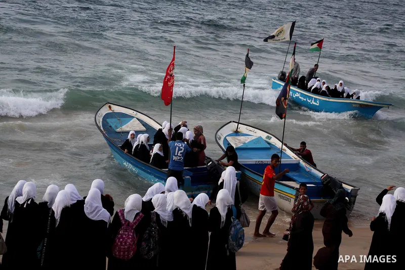 Palestinian girls ride on the deck of a boat off the coast of Gaza city during a school trip on October 21, 2012. Gaza beach is the only outlet for the Palestinians after tightening the Israeli blockade on the Gaza Strip...