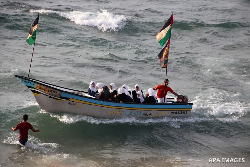 Palestinian girls ride on the deck of a boat off the coast of Gaza city during a school trip on October 21, 2012. Gaza beach is the only outlet for the Palestinians after tightening the Israeli blockade on the Gaza Strip...
