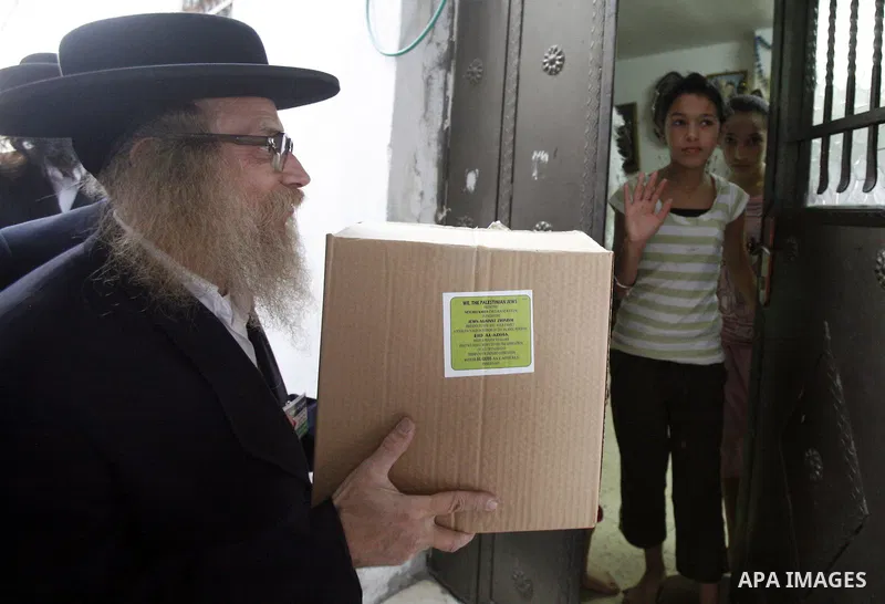 Members of Jewish Neturei Karta deliver humanitarian aid to Palestinian needy families in al-Tur neighborhood in Jerusalem on October. 21, 2012. Neturei Karta opposes Zionism and calls for a peaceful dismantling of the S...