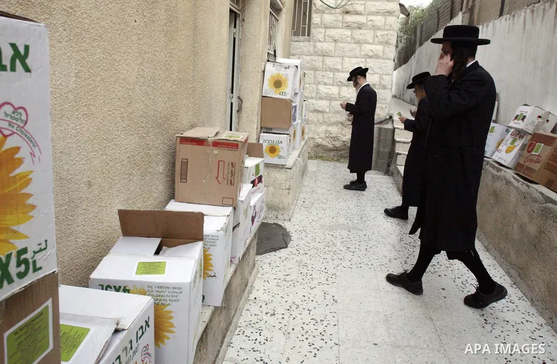 Members of Jewish Neturei Karta deliver humanitarian aid to Palestinian needy families in al-Tur neighborhood in Jerusalem on October. 21, 2012. Neturei Karta opposes Zionism and calls for a peaceful dismantling of the S...