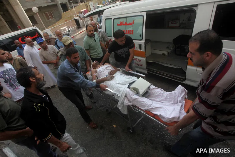 Health workers wheel a wounded Palestinian man from the village of Beit Lahia in the northern Gaza Strip outside the al-Shafa hospital in Gaza City on October 22, 2012, following as Israeli airstrike. Three Palestinians...