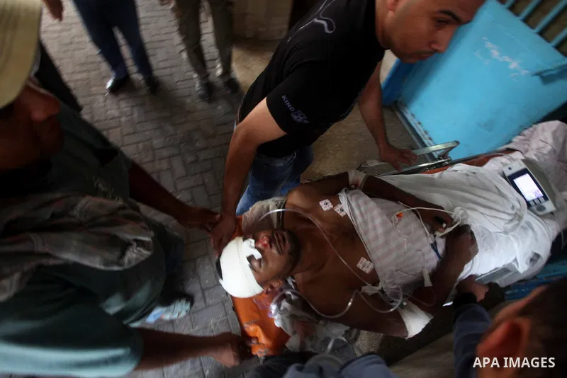 Health workers wheel a wounded Palestinian man from the village of Beit Lahia in the northern Gaza Strip outside the al-Shafa hospital in Gaza City on October 22, 2012, following as Israeli airstrike. Three Palestinians...
