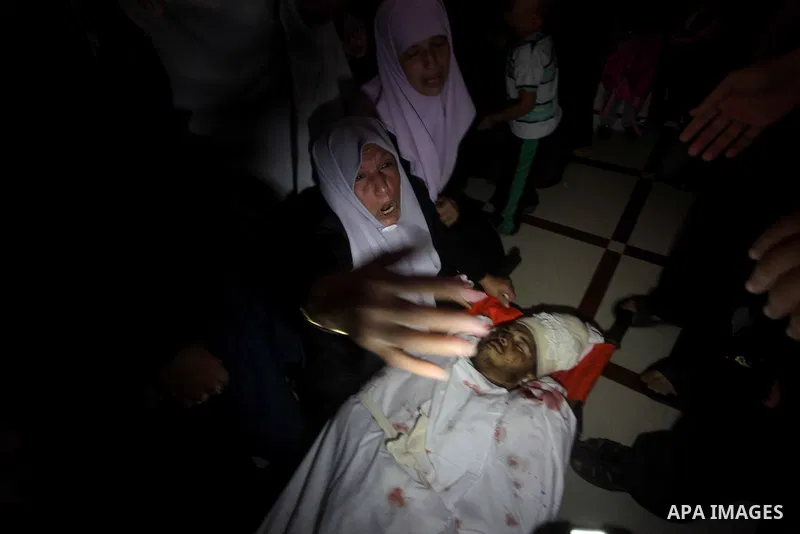Palestinian women mourn over the body of Abderahman Abu Jalaleh, 25, during his funeral in Beit Lahia, in the northern Gaza Strip, on October 22, 2012. An Israeli air strikes killed two Gaza militants as they clashed wit...