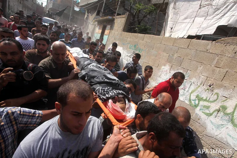 Palestinian mourners carry the body of Yasser al-Tarabeen during his funeral procession in Beit Hanun, in northern Gaza Strip, on October 22, 2012. Israeli air strikes killed two Gaza militants as they clashed with troop...