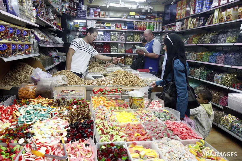 Palestinians shop in the main market during preparations for the Eid al-Adha, in the West Bank city of Jerusalem, on October 22, 2012. Muslims around the world prepare to celebrate Eid Al-Adha, which according to the lun...