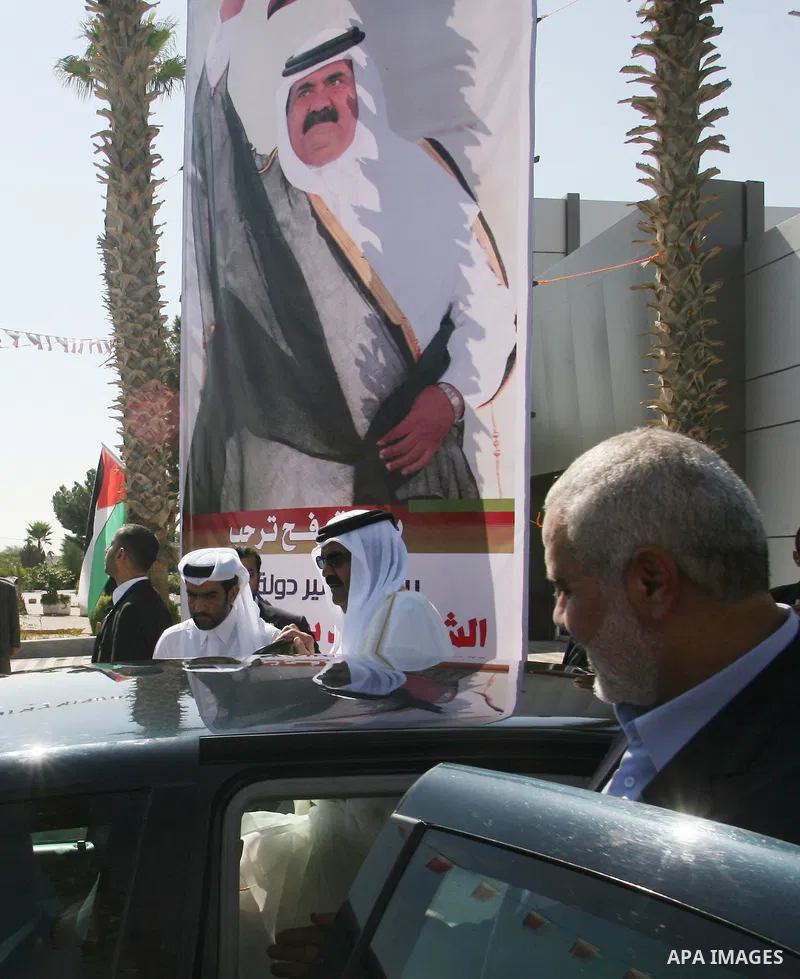 Palestinian Prime Minister in Gaza strip, Ismail Haniyeh walks with the Emir of Qatar Sheik Hamad bin Khalifa al-Thani during a welcoming ceremony at the Rafah border crossing with Egypt in the southern Gaza Strip Octobe...