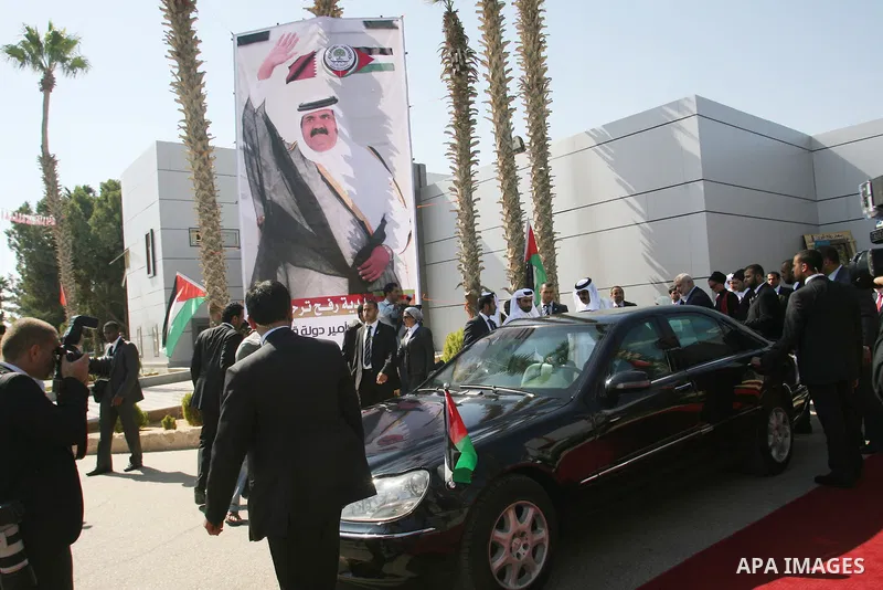 Palestinian Prime Minister in Gaza strip, Ismail Haniyeh walks with the Emir of Qatar Sheik Hamad bin Khalifa al-Thani during a welcoming ceremony at the Rafah border crossing with Egypt in the southern Gaza Strip Octobe...