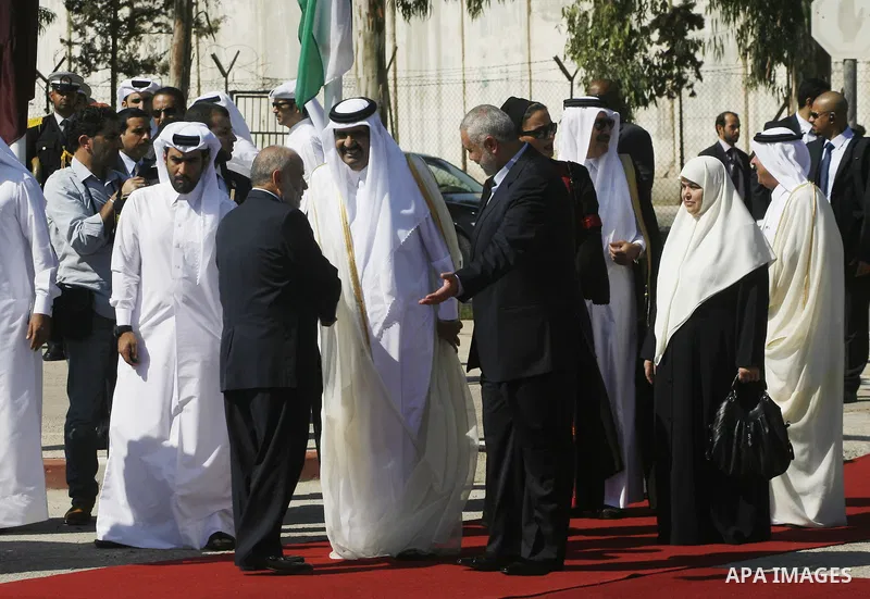 Palestinian Prime Minister in Gaza strip, Ismail Haniyeh walks with the Emir of Qatar Sheik Hamad bin Khalifa al-Thani during a welcoming ceremony at the Rafah border crossing with Egypt in the southern Gaza Strip Octobe...