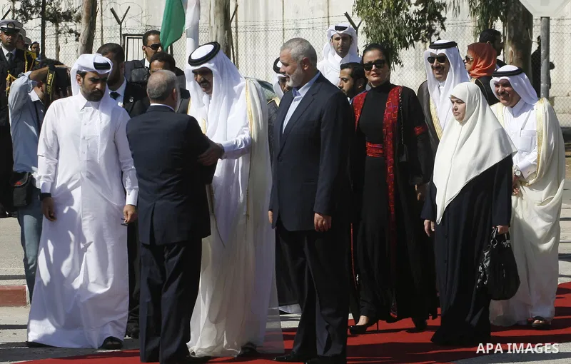 Palestinian Prime Minister in Gaza strip, Ismail Haniyeh walks with the Emir of Qatar Sheik Hamad bin Khalifa al-Thani during a welcoming ceremony at the Rafah border crossing with Egypt in the southern Gaza Strip Octobe...