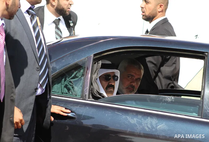 Palestinian Prime Minister in Gaza Strip, Ismail Haniyeh with the Emir of Qatar Sheik Hamad bin Khalifa al-Thani arrive to attend the opening ceremony for housing project in the southern Gaza Strip town of Khan Yunis, Oc...