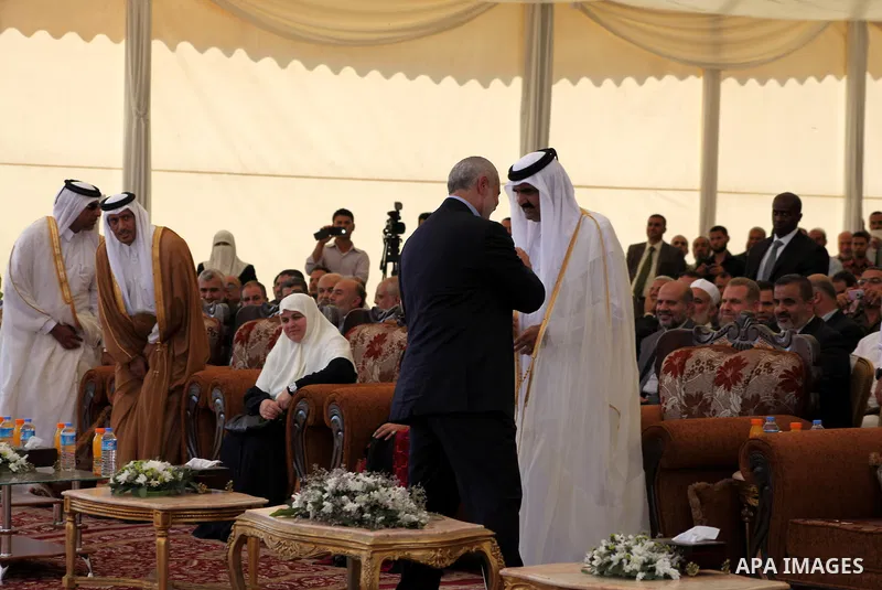 Palestinian Prime Minister in Gaza strip, Ismail Haniyeh and the Emir of Qatar Sheikh Hamad bin Khalifa al-Thani arrive at a cornerstone laying ceremony for Hamad, a new residential neighbourhood in Khan Younis in the so...