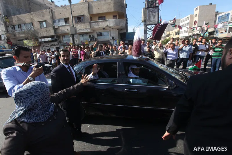 Palestinians gather around the convoy of the Qatari Emir Sheikh Hamad bin Khalifa Al-Thani in Gaza City, Tuesday, Oct. 23,2012. The Emir of Qatar entered the Gaza Strip on Tuesday for a visit that broke the isolation of...