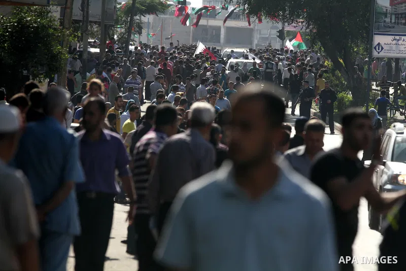 Palestinians gather around the convoy of the Qatari Emir Sheikh Hamad bin Khalifa Al-Thani in Gaza City, Tuesday, Oct. 23,2012. The Emir of Qatar entered the Gaza Strip on Tuesday for a visit that broke the isolation of...
