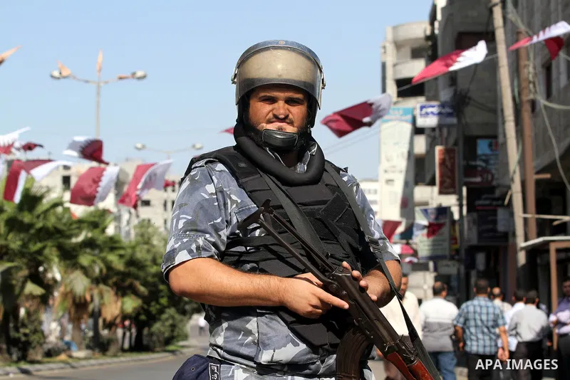 Palestinian Hamas security officers guard a road as they wait for the convoy of the Qatari Emir Sheikh Hamad bin Khalifa Al-Thani to arrive in Gaza City, Tuesday, Oct. 23,2012. The Emir of Qatar entered the Gaza Strip on...