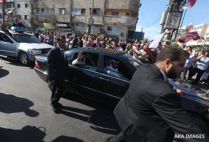 Palestinians gather around the convoy of the Qatari Emir Sheikh Hamad bin Khalifa Al-Thani in Gaza City, Tuesday, Oct. 23,2012. The Emir of Qatar entered the Gaza Strip on Tuesday for a visit that broke the isolation of...
