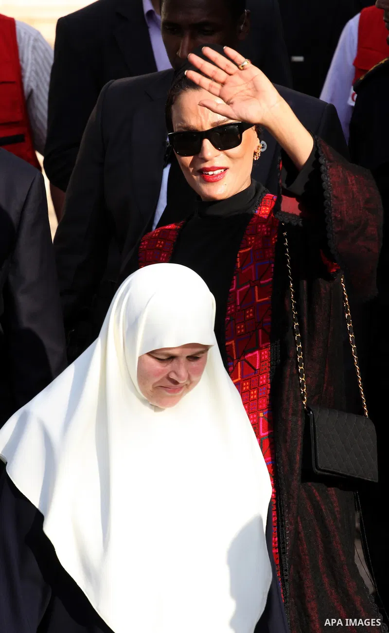 Qatar's First Lady Sheikha Mozah bint Nasser al-Missned leaves the Atfaluna Society for Deaf Children with the wife of Gaza's Hamas prime minister Ismail Haniya in the Gaza Strip on October 23, 2012. The Emir of Qatar en...
