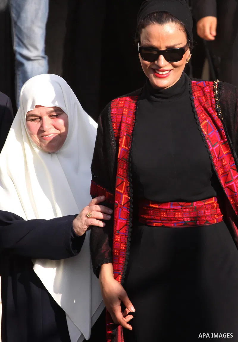Qatar's First Lady Sheikha Mozah bint Nasser al-Missned leaves the Atfaluna Society for Deaf Children with the wife of Gaza's Hamas prime minister Ismail Haniya in the Gaza Strip on October 23, 2012. The Emir of Qatar en...