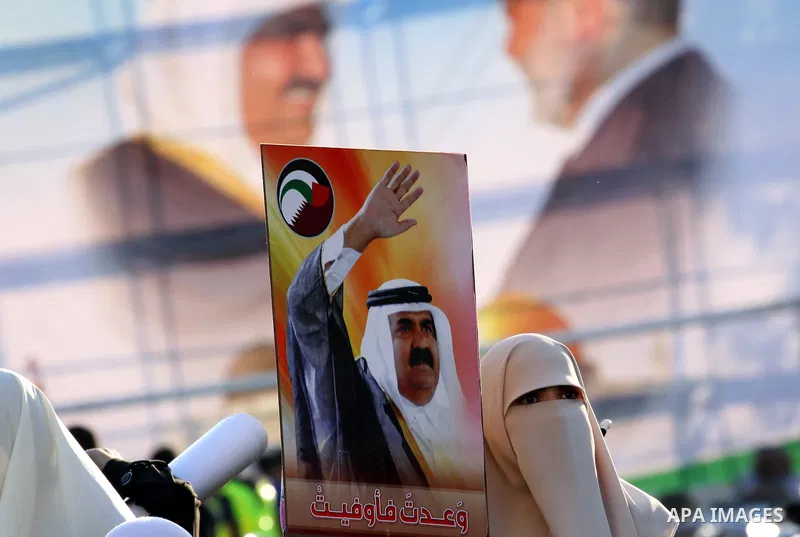 Palestinians stand near posters of the Emir of Qatar Sheikh Hamad bin Khalifa al-Thani in the Gaza city on October 23, 2012. The Emir of Qatar entered the Gaza Strip on Tuesday for a visit that broke the isolation of it...
