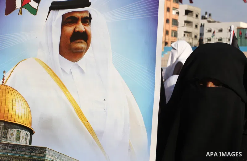 Palestinians stand near posters of the Emir of Qatar Sheikh Hamad bin Khalifa al-Thani in the Gaza city on October 23, 2012. The Emir of Qatar entered the Gaza Strip on Tuesday for a visit that broke the isolation of it...