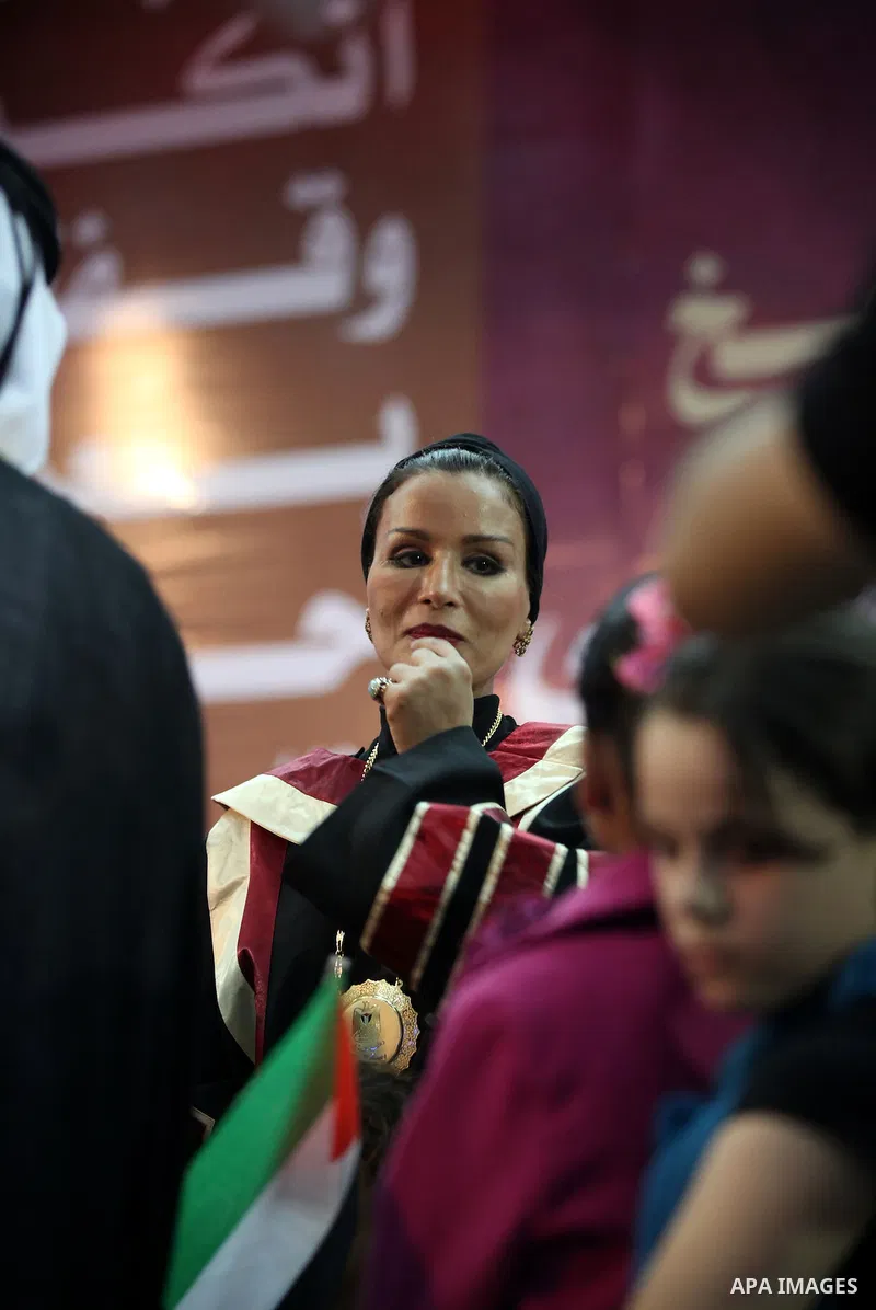 Qatar's First Lady Sheikha Mozah bint Nasser al-Missned stands with the wife of Gaza's prime minister Ismail Haniyah surrounding with Palestinian children at the Islamic University in Gaza city on October 23, 2012. The E...