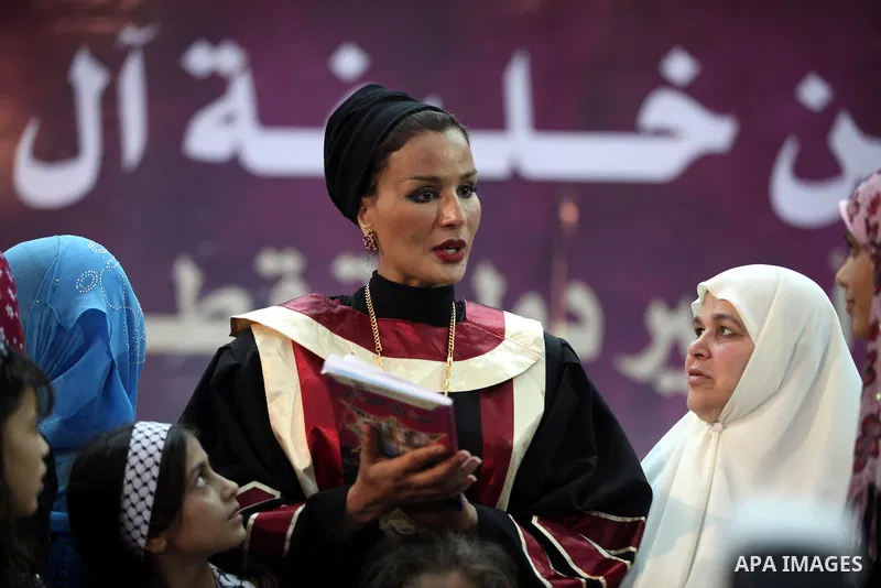 Qatar's First Lady Sheikha Mozah bint Nasser al-Missned stands with the wife of Gaza's prime minister Ismail Haniyah surrounding with Palestinian children at the Islamic University in Gaza city on October 23, 2012. The E...