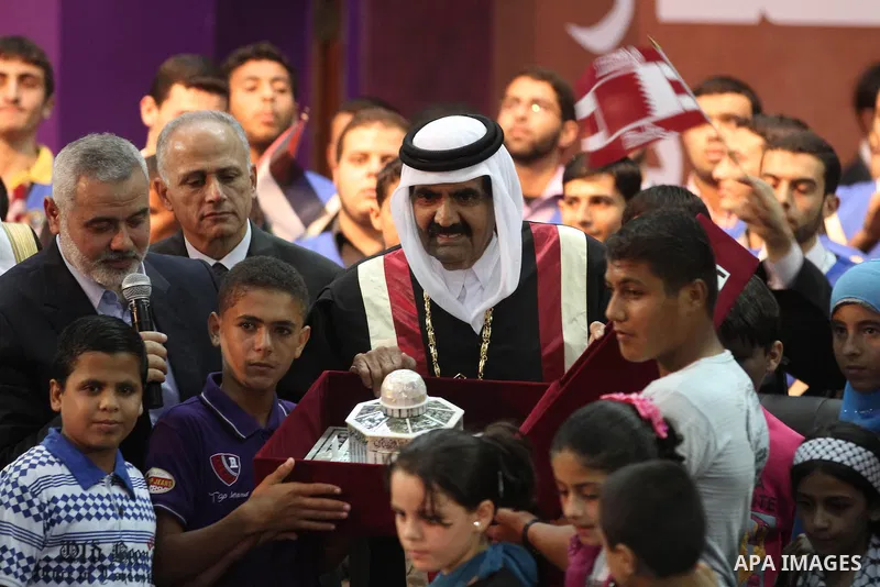 Qatari Emir Sheikh Hamad bin Khalifa al-Thani and Palestinian prime minister in Gaza strip, Ismail Haniyah attend a celebration at the Islamic University in Gaza city on October 23, 2012. The Emir of Qatar entered the Ga...